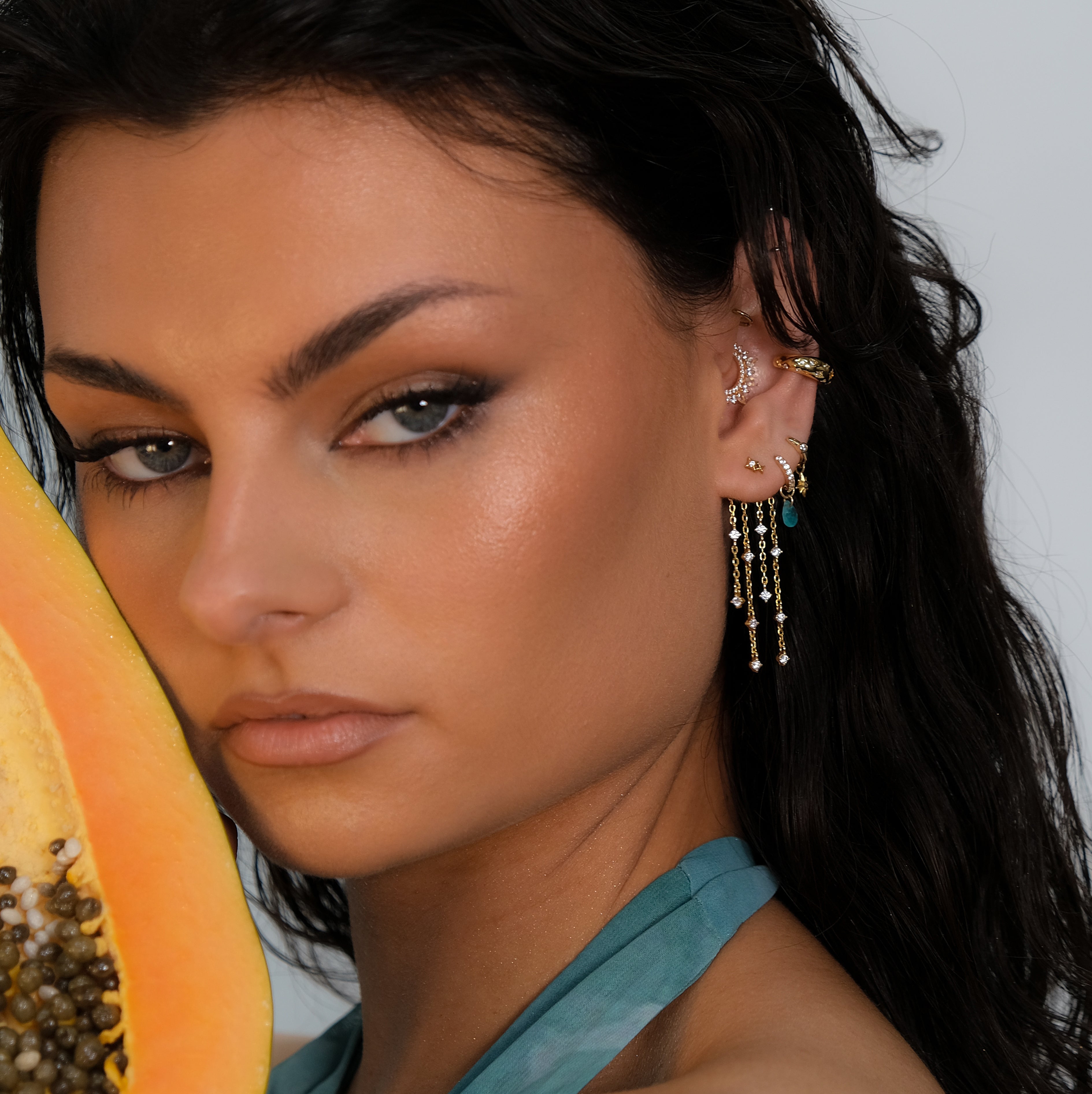 Woman with feminine elegance wears Crystal Heaven London BAHIA Waterfall Floating Charm.