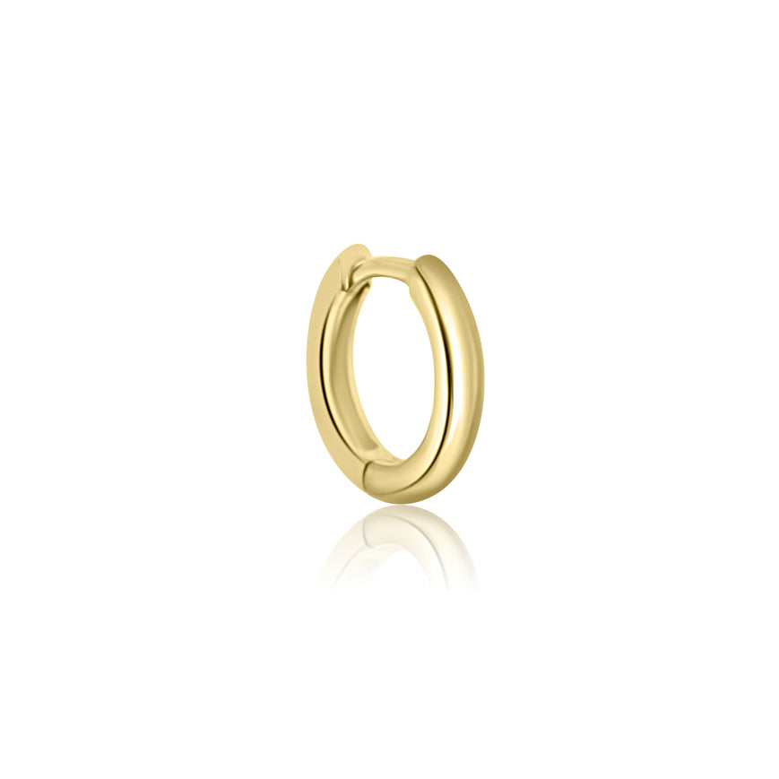 The CHLUXE Classic Huggie Hoop by Crystal Heaven London, crafted in 14K yellow gold, is elegantly displayed on a pristine white background.