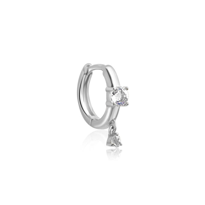 A silver hoop earring with a clear gemstone, set against a white background, echoes the elegance of the CHLUXE Moonstone Droplet Huggie Hoop by Crystal Heaven London in 14K White Gold.