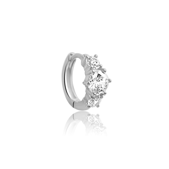 The CHLUXE Stacked Crystal Huggie Hoop by Crystal Heaven London is crafted in 14K White Gold, showcasing three round diamonds against a white background.
