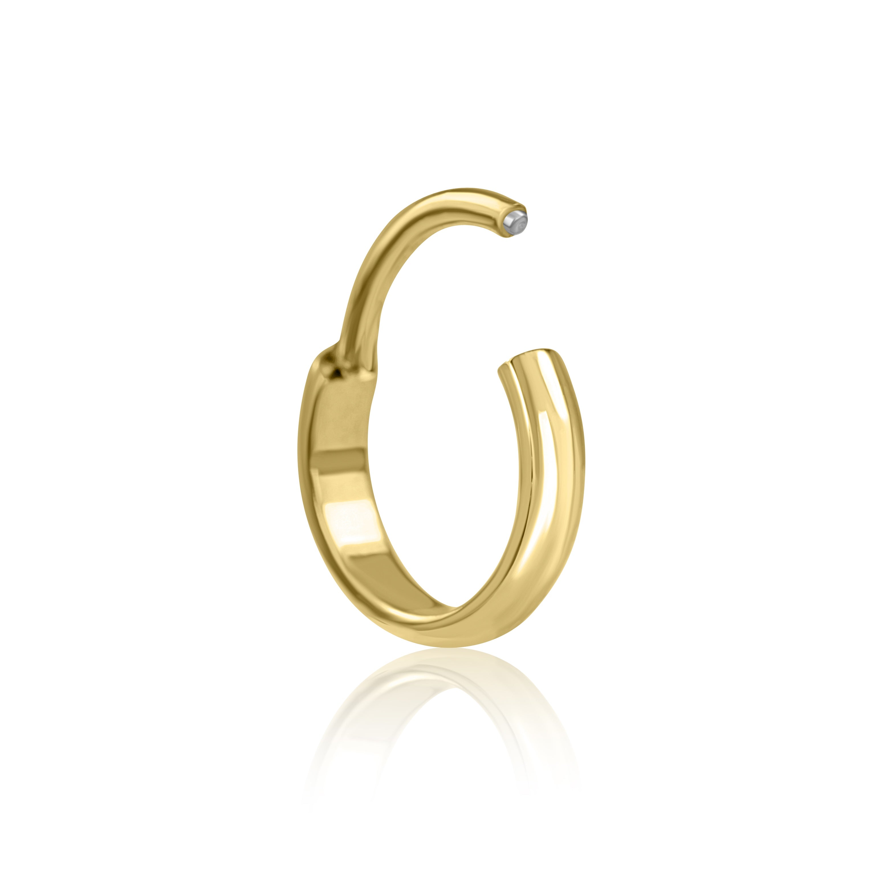 The Bold Cartilage Hoop (18g) by Crystal Heaven London is a gold-colored, open-ended ring made from implant-grade titanium with a small gemstone on one tip, elegantly displayed on a reflective surface.