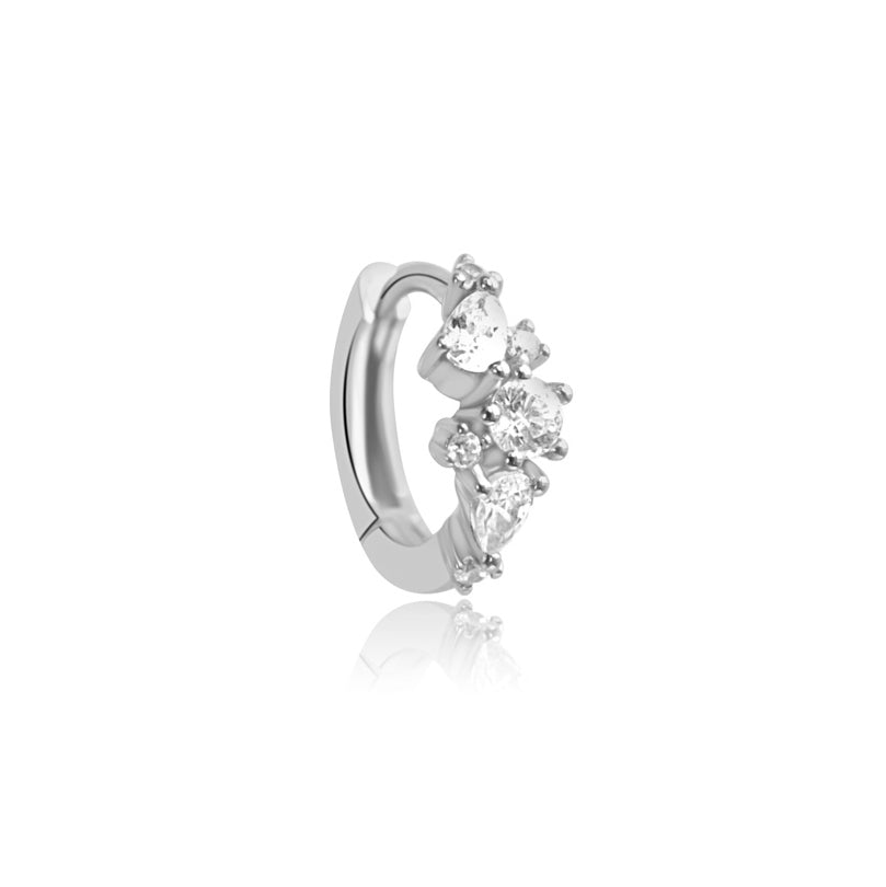Explore the elegant MARGOT Scattered Gem Huggie Hoops by Crystal Heaven London, crafted with sterling silver and adorned with five heart-shaped and round gemstones on a white background featuring sparkling cubic zirconia.