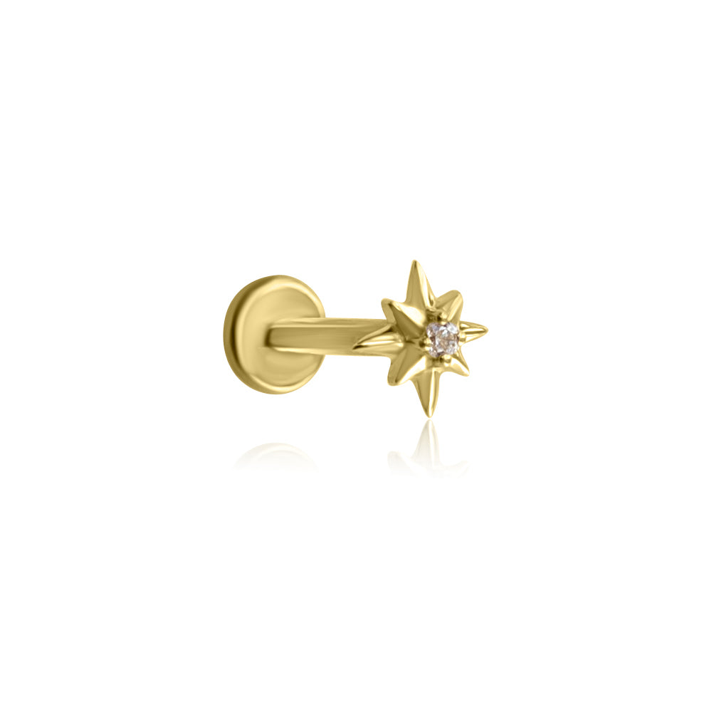 The VENUS Threadless Cartilage Stud by Crystal Heaven London features a gold star-shaped design with a central diamond on a flat back post, inspired by the North Star.