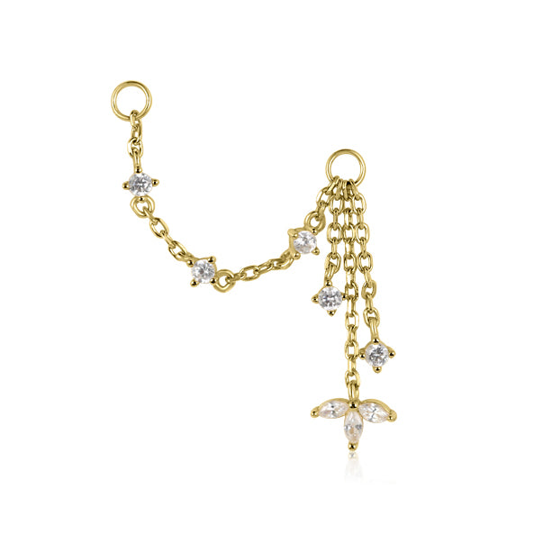 The LANI Marquise Droplet Chain Charm by Crystal Heaven London is a gold chain earring with white stone accents, featuring two strands and a flower-like cluster at one end, ideal for layering in an ear stack.